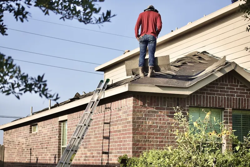 Professional roofer working on a residential roof in Cranbury Station